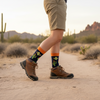 Person wearing hiking boots and cactus-themed socks in a desert setting